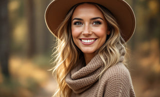 Woman in a wide-brim hat on a pine-lined North Idaho trail in soft early-autumn light
