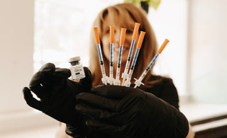Nurse holding peptide shots
